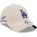 casquette-courbee-beige-ajustable-avec-logo-bleu-9twenty-linen-spring-training-fan-pack-2025-los-angeles-dodgers-mlb-new-era